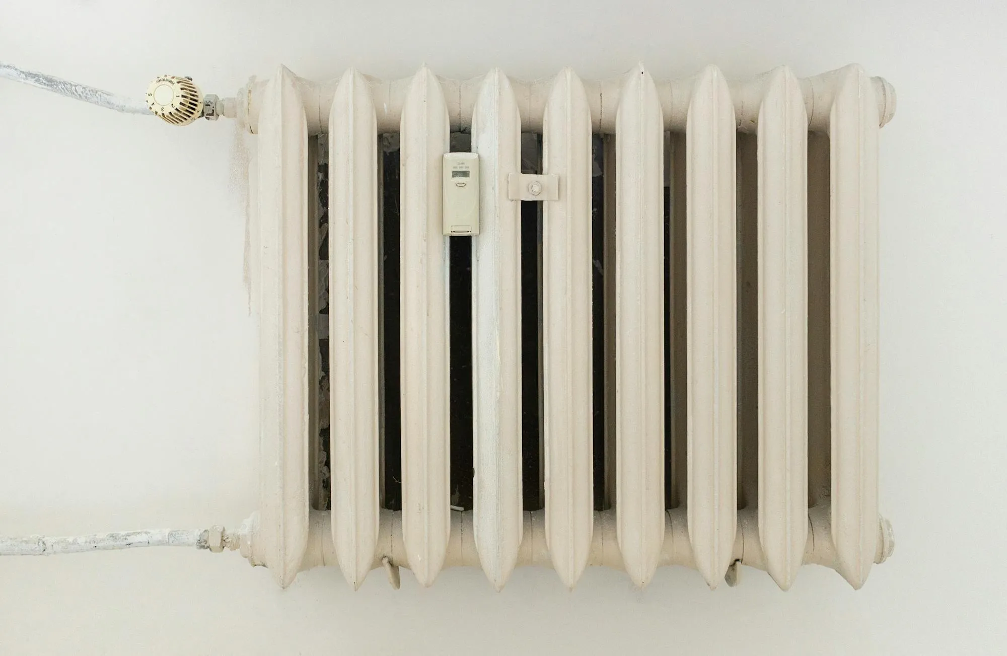 Cast-iron column radiator on a plain white wall, the kind found in older Sheffield terraces